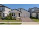 Charming single-story home featuring a cozy front porch, two-car garage, and beautifully landscaped front yard at 16055 Silver Brook Way, Winter Garden, FL 34787
