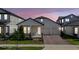 Charming single-story home featuring a cozy front porch, two-car garage, and beautifully landscaped front yard at 16055 Silver Brook Way, Winter Garden, FL 34787