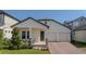 Charming single-story home featuring a cozy front porch, two-car garage, and beautifully landscaped front yard at 16055 Silver Brook Way, Winter Garden, FL 34787