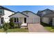 Charming single-story home featuring a cozy front porch, two-car garage, and beautifully landscaped front yard at 16055 Silver Brook Way, Winter Garden, FL 34787