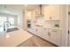 Modern kitchen featuring sleek white cabinets, stainless steel appliances, and stylish backsplash at 16055 Silver Brook Way, Winter Garden, FL 34787