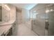 A luxurious main bathroom boasts dual vanities, a soaking tub, and a glass-enclosed shower, creating a spa-like retreat at 16055 Silver Brook Way, Winter Garden, FL 34787
