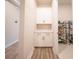 Hallway mudroom features white cabinets with modern hardware, wood-look floors, and a storage shelf at 16055 Silver Brook Way, Winter Garden, FL 34787