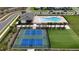 Aerial shot showcasing tennis courts, pool and green space in a Primary-planned community at 16055 Silver Brook Way, Winter Garden, FL 34787