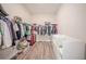 Spacious walk-in closet with ample storage racks, shelves, and wood-look flooring at 16055 Silver Brook Way, Winter Garden, FL 34787