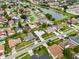 Aerial view of a residential neighborhood with a pond at 1616 Golden Poppy Ct, Orlando, FL 32824