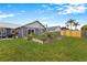 Beautiful backyard with lush green lawn and raised garden at 1616 Golden Poppy Ct, Orlando, FL 32824