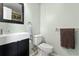 Modern bathroom features a wall-mounted sink, toilet, and towel bars at 1616 Golden Poppy Ct, Orlando, FL 32824