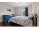 Comfortable bedroom showcases a patterned bed, a blue dresser, and natural light from the window at 1616 Golden Poppy Ct, Orlando, FL 32824