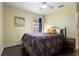 Cozy bedroom with a queen bed, ceiling fan and a window at 1616 Golden Poppy Ct, Orlando, FL 32824