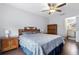 Bedroom with a cozy bed, dark wood furniture, and ceiling fan at 1616 Golden Poppy Ct, Orlando, FL 32824