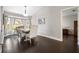 Bright dining room with hardwood floors, stylish furniture, and natural light from bay window at 1616 Golden Poppy Ct, Orlando, FL 32824
