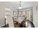 Bright dining room with hardwood floors, stylish furniture, and natural light from bay window at 1616 Golden Poppy Ct, Orlando, FL 32824