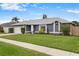 Beautiful one-story home with manicured lawn, flowers and mature trees in a suburban neighborhood at 1616 Golden Poppy Ct, Orlando, FL 32824