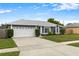 Charming single-story home featuring a two-car garage, driveway, and beautifully landscaped front yard at 1616 Golden Poppy Ct, Orlando, FL 32824
