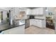 Well-lit kitchen with stainless steel appliances, black granite countertops, and neutral tiling at 1616 Golden Poppy Ct, Orlando, FL 32824