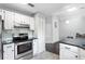 Bright kitchen featuring white cabinets, modern appliances, and functional layout at 1616 Golden Poppy Ct, Orlando, FL 32824