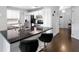 Modern kitchen featuring white cabinets, dark countertops, and stainless-steel appliances at 1616 Golden Poppy Ct, Orlando, FL 32824