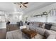 Cozy living room with sectional sofa, coffee table, and open access to the kitchen and dining area at 1616 Golden Poppy Ct, Orlando, FL 32824