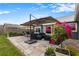 Back patio area with umbrella, seating, and lush garden at 1616 Golden Poppy Ct, Orlando, FL 32824