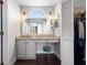 Vanity area with an arched window and an adjacent walk-in closet at 1616 Golden Poppy Ct, Orlando, FL 32824