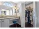 Walk-in closet with a full wardrobe, shelving and a vanity outside at 1616 Golden Poppy Ct, Orlando, FL 32824