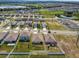 Scenic aerial view of a residential area surrounded by greenery and a nearby lake, showing community living at 1791 Hackberry St, Clermont, FL 34715