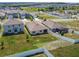 A stunning aerial view of the backyards of suburban homes with well-maintained lawns and white fences at 1791 Hackberry St, Clermont, FL 34715