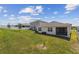 Spacious backyard featuring a lush lawn and a screened-in patio, perfect for outdoor entertaining at 1791 Hackberry St, Clermont, FL 34715