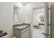Bright bathroom with vanity, granite countertop, and an open doorway to another room at 1791 Hackberry St, Clermont, FL 34715