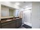 Well-lit bathroom with a double sink vanity and a walk-in shower at 1791 Hackberry St, Clermont, FL 34715