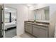 Bathroom with double sinks and a view into the bedroom at 1791 Hackberry St, Clermont, FL 34715