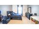 Comfortable bedroom with blue accents, a large bed, and a dresser with a mirror at 1791 Hackberry St, Clermont, FL 34715