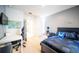 Bedroom with a world map decoration, a bed with blue sonic-themed bedding, and a white desk at 1791 Hackberry St, Clermont, FL 34715