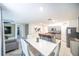 Open-concept dining area with stylish table and chairs, and a modern kitchen island nearby at 1791 Hackberry St, Clermont, FL 34715
