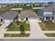 Well-maintained home featuring a pristine lawn, tidy landscaping, and a paved driveway leading to a garage at 1791 Hackberry St, Clermont, FL 34715
