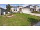 Beautifully landscaped front yard featuring vibrant green grass and a well-manicured garden at 1791 Hackberry St, Clermont, FL 34715