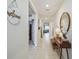 Inviting hallway featuring neutral-toned walls, a stylish console table and a decorative mirror at 1791 Hackberry St, Clermont, FL 34715