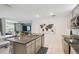Bright kitchen features granite counters, stainless steel appliances, and an island with seating at 1791 Hackberry St, Clermont, FL 34715