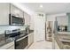 Well-equipped kitchen with stainless steel appliances, granite countertops, and ample cabinet space at 1791 Hackberry St, Clermont, FL 34715