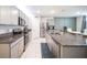 Well-equipped kitchen boasts stainless steel appliances, granite countertops, and an island for gathering at 1791 Hackberry St, Clermont, FL 34715