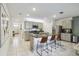 Bright kitchen featuring a large island with barstool seating and sleek, stainless steel appliances at 1791 Hackberry St, Clermont, FL 34715