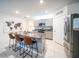 Kitchen island with granite countertop, stainless steel appliances, and bar stool seating at 1791 Hackberry St, Clermont, FL 34715