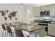 Modern kitchen featuring an island with seating, stainless steel appliances, and ample counter space at 1791 Hackberry St, Clermont, FL 34715