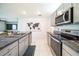 Kitchen featuring a granite countertop, stainless steel oven, microwave and adjacent dining area at 1791 Hackberry St, Clermont, FL 34715