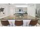 Spacious kitchen island with barstool seating, stainless steel appliances, and granite countertops at 1791 Hackberry St, Clermont, FL 34715