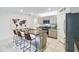 Modern kitchen featuring an island with seating, stainless steel appliances, and ample counter space at 1791 Hackberry St, Clermont, FL 34715