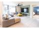 Comfortable living room featuring tile floors, a large sectional sofa, and stylish decor at 1791 Hackberry St, Clermont, FL 34715