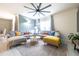 Bright living room featuring tile floors, two large sectional sofas, and stylish decor at 1791 Hackberry St, Clermont, FL 34715
