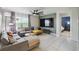 Comfortable living room features a large TV, sectional sofa, and stylish decor creating an inviting space at 1791 Hackberry St, Clermont, FL 34715